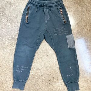 Grey Zara’s drop crotch sweatpants with side zippers and word design all over.